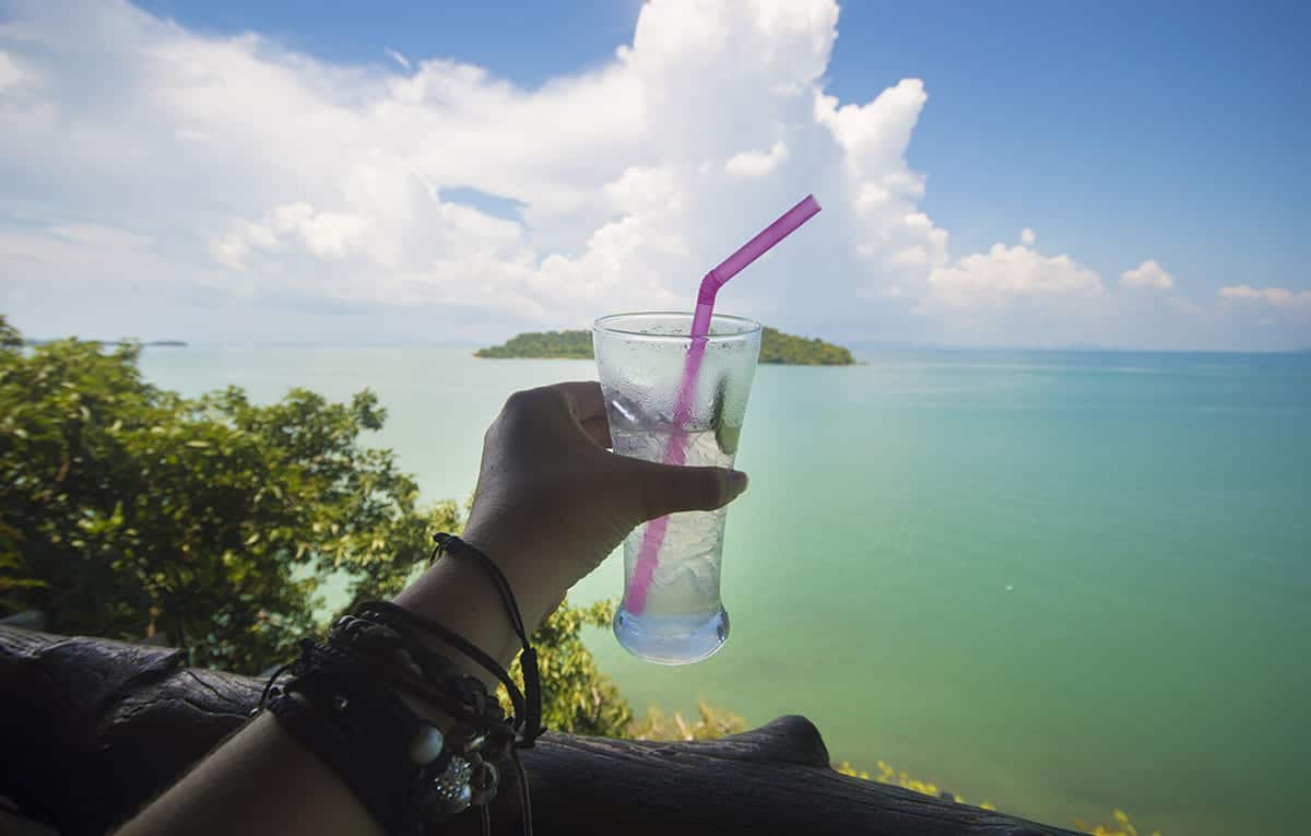 Backpacking Koh Lanta: TOP Things To Do & Itinerary 2025 19 enjoying a cold drink by the ocean in koh lanta