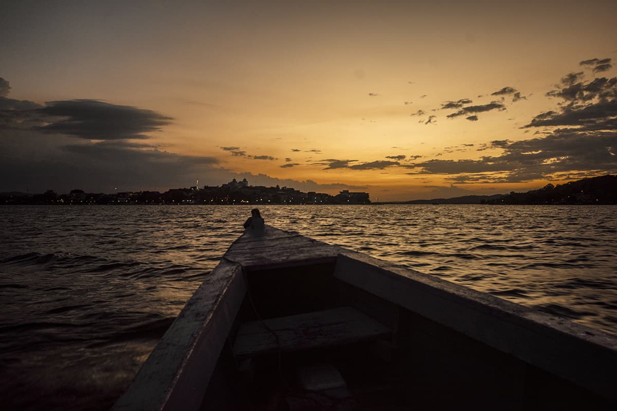 3 Weeks In Guatemala Itinerary: BEST Route For First Timers 21 taking a sunset boat ride with the island of flores in the distance