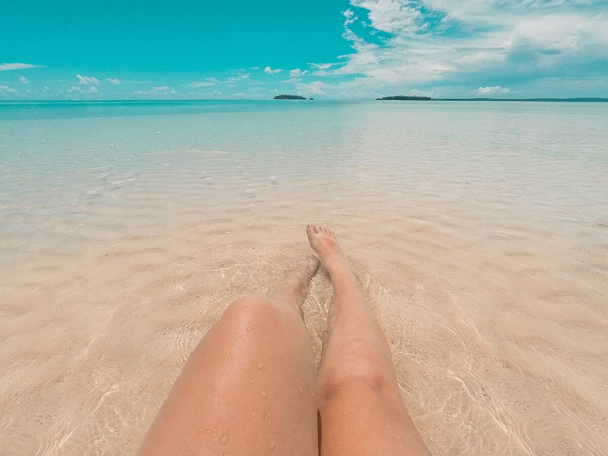 Aitutaki Day Tour From Rarotonga: Air Rarotonga Review 4 enjoying the shallow waters sitting on a sand bar in aitutaki