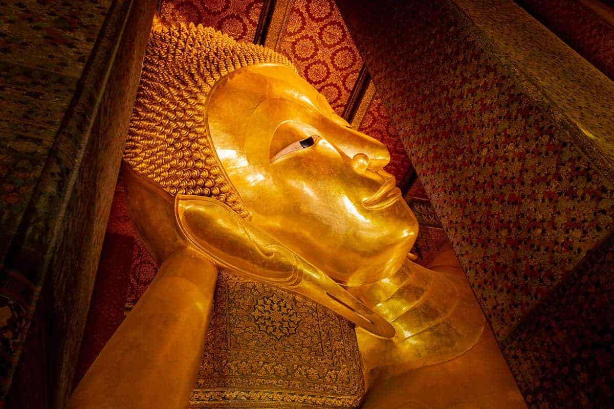 Backpacking Bangkok: All You Need To Know 15 the face of the golden reclining buddha in wat po bangkok