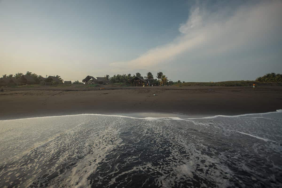 Backpacking Guatemala: The Ultimate Budget Guide 2025 43 playing in the shallows on the black sand beach of playa el paredon