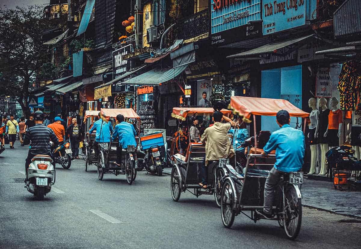Backpacking Hanoi On A Budget: My Top Travel Tips 27 busy streets of hanoi filled with cycle rickshaws and motorbikes