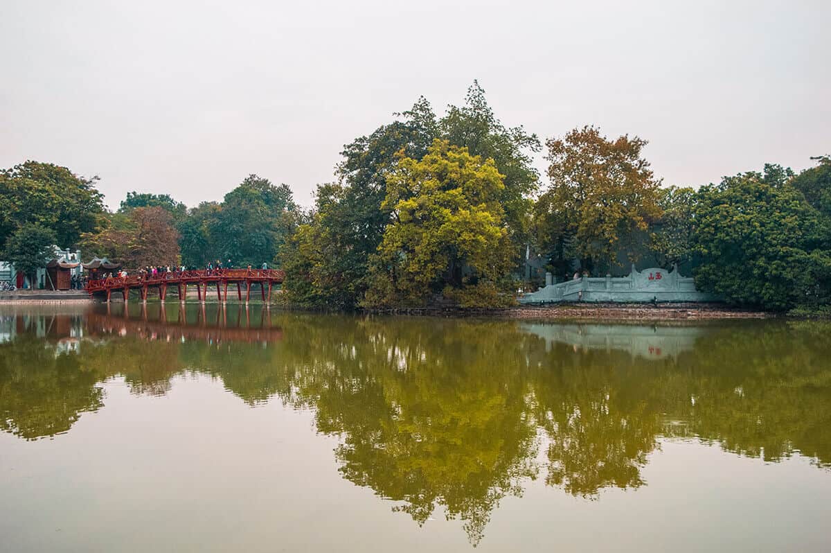 Backpacking Hanoi On A Budget: My Top Travel Tips 30 ho hoan kiem lake in hanoi with the bridge leading to the temple in the middle