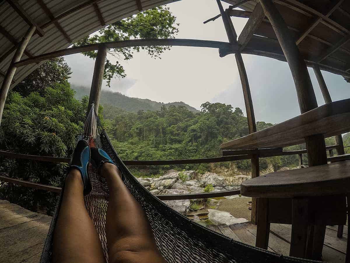Backpacking Honduras: The Ultimate Guide For Backpackers & First Time Visitors 2025 28 hanging out in a hammock at pico bonito national park in my water shoes