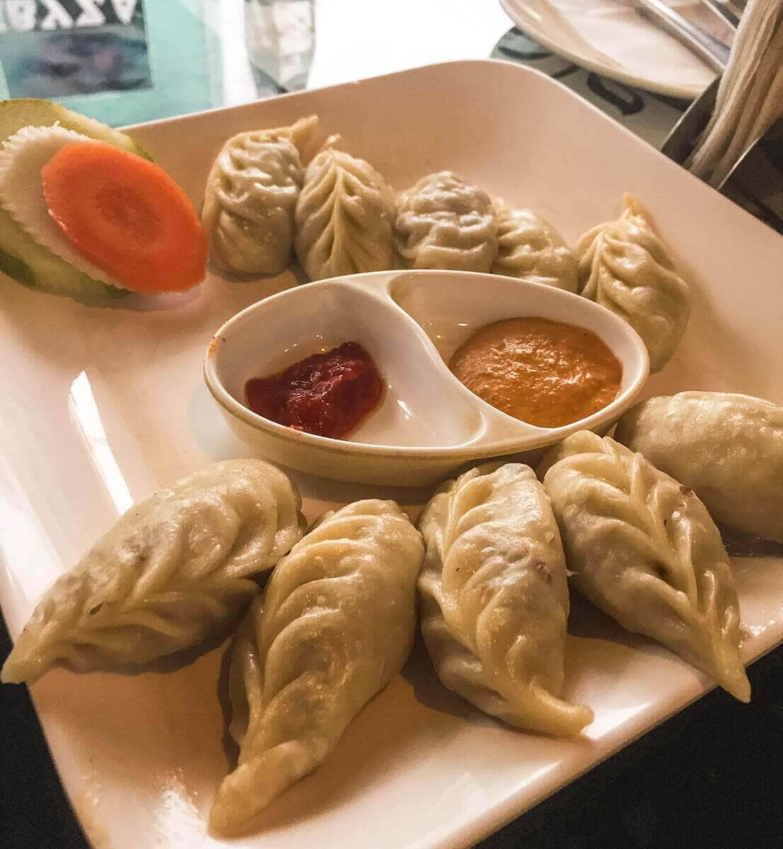 Backpacking Kathmandu: Everything Travelers Need To Know 7 thamel momo hut steamed momos with side salad in kathmandu