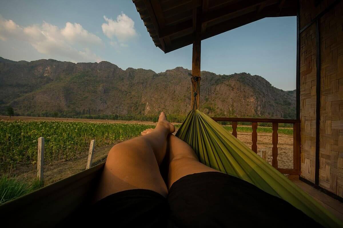 relaxing in a hammock while backpacking laos