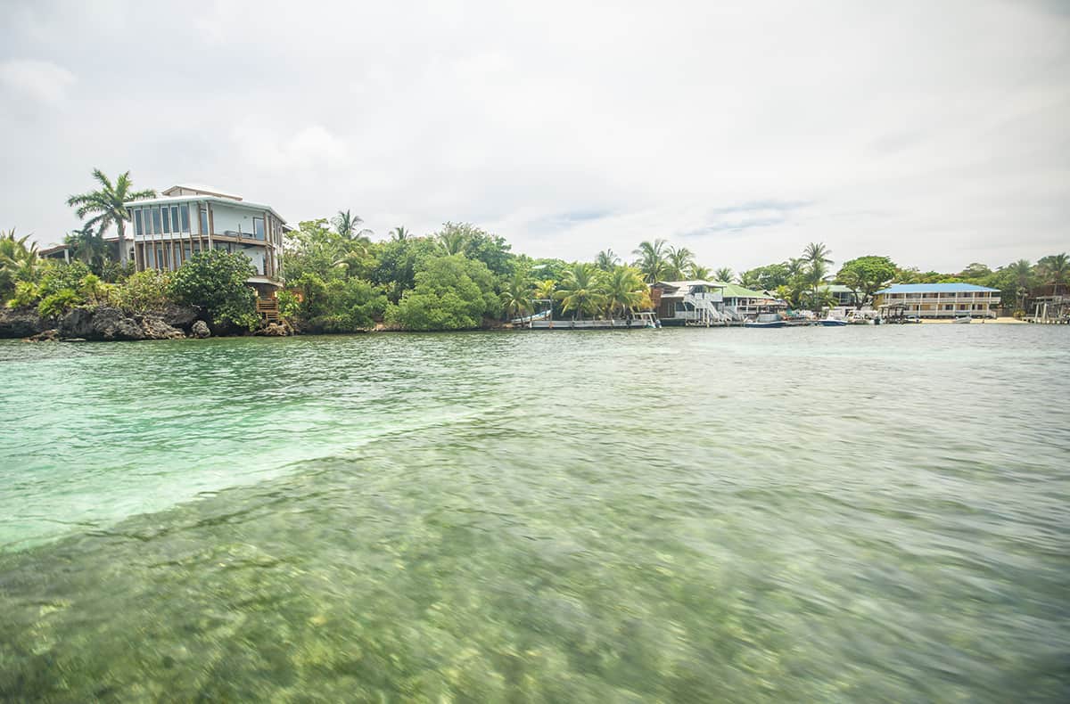 Backpacking Roatan & BEST Hostels In Roatan (2025) 27 the beautiful turquoise waters and fancy holiday homes in roatan