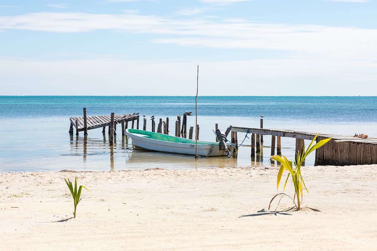 Belize City To San Ignacio: CHEAPEST Ways To Travel 10 a single boat chilling in the calm waters around caye caulker