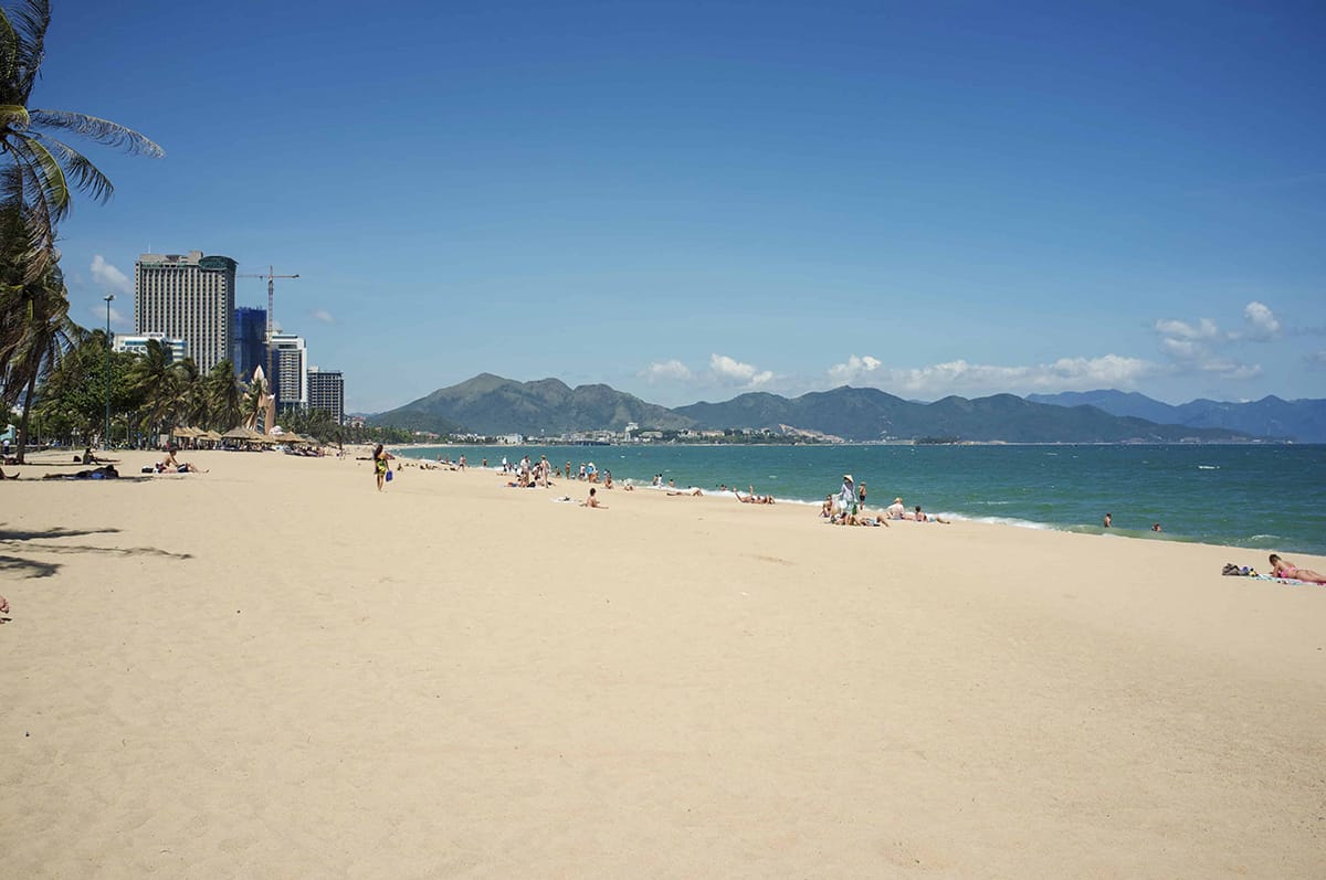 Best 8 Beaches In Nha Trang You NEED To Visit! 5 people enjoying the sea at nha trang beach