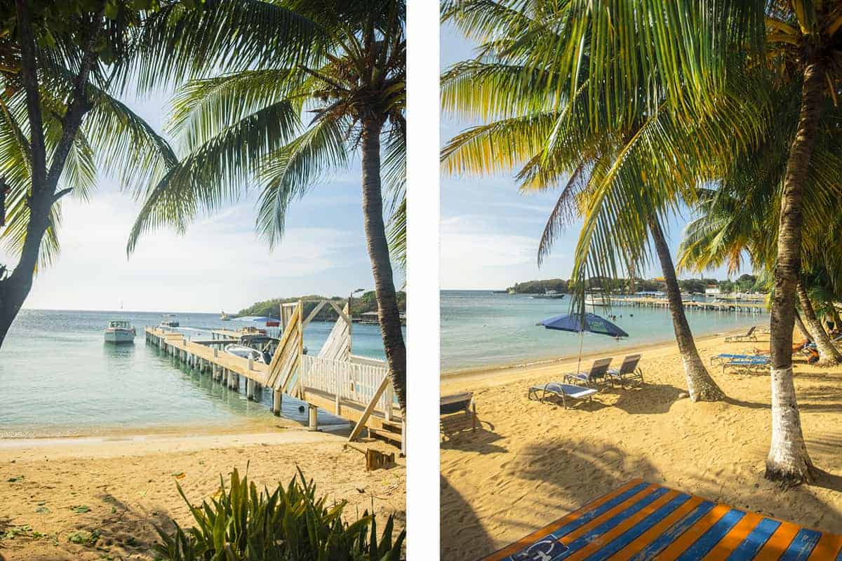 The 9 BEST Beaches In Roatan Worth Visiting 2025 8 golden shores with a couple of beach chairs lined up on half moon bay beach in roatan