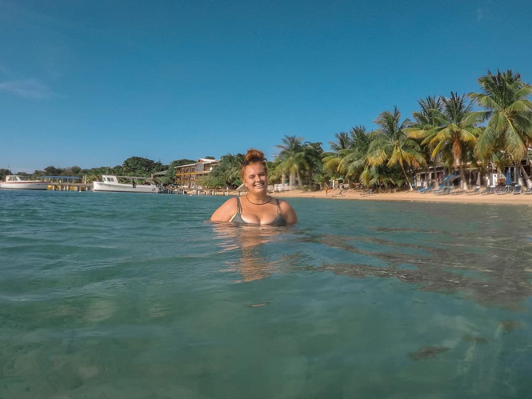 The 9 BEST Beaches In Roatan Worth Visiting 2025 30 enjoying the sun and water on half moon bay one of the best beaches in roatan honduras