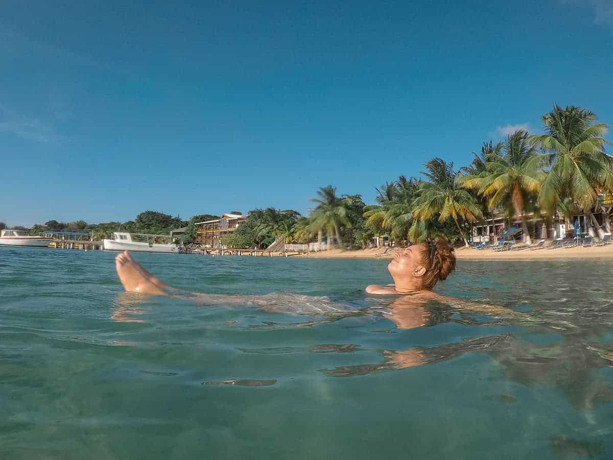 The 9 BEST Beaches In Roatan Worth Visiting 2025 16 enjoying the beautiful water on a sunny day in half moon bay roatan