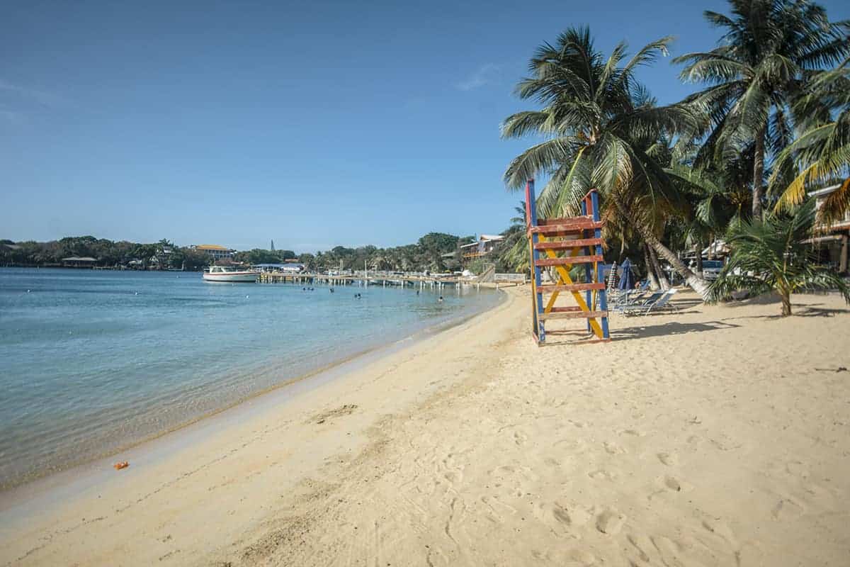 The 9 BEST Beaches In Roatan Worth Visiting 2025 9 a colorful lifeguard tower on the sandy shores of half moon bay in roatan