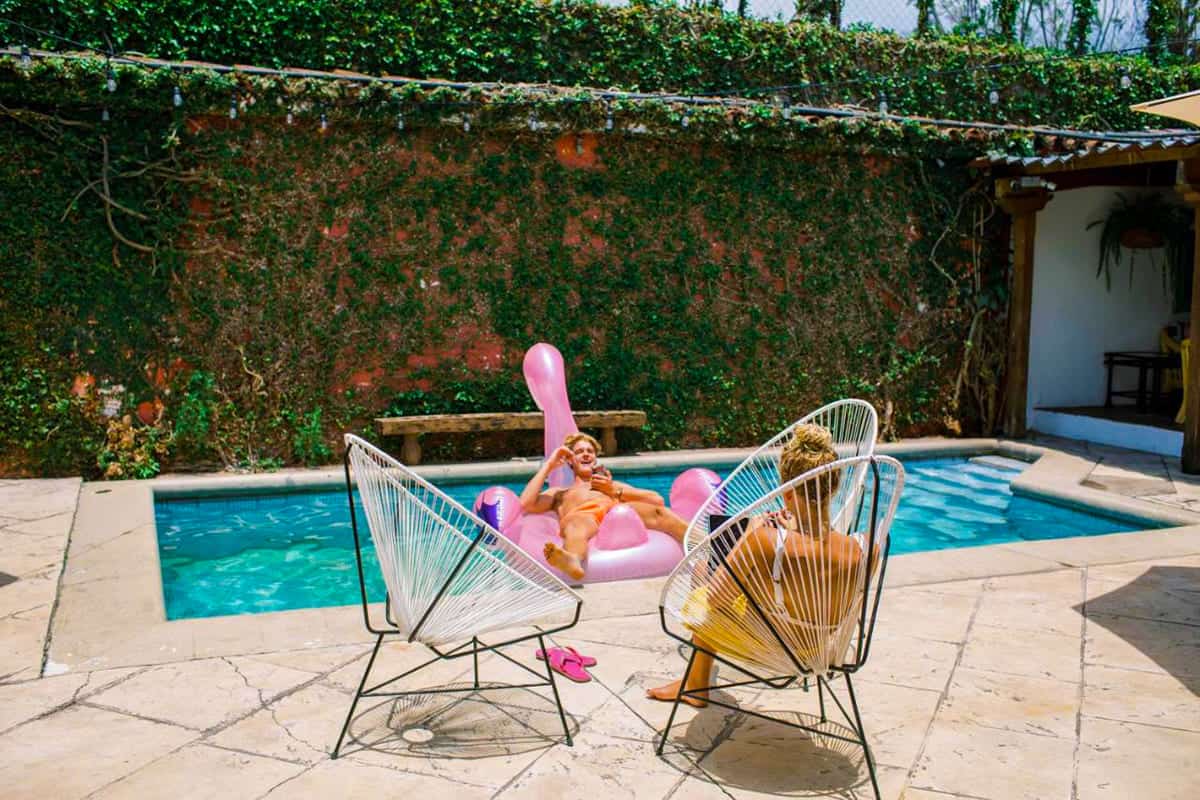 Best Hostels In Antigua, Guatemala: Best Stays In 2025 36 relaxing around the pool at casi casa on a warm day, one of the best hostels in antigua guatemala