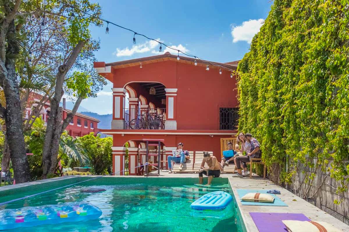 Best Hostels In Antigua, Guatemala: Best Stays In 2025 35 relaxing around the pool at antigua selina, the best hostel in antigua for digital nomads