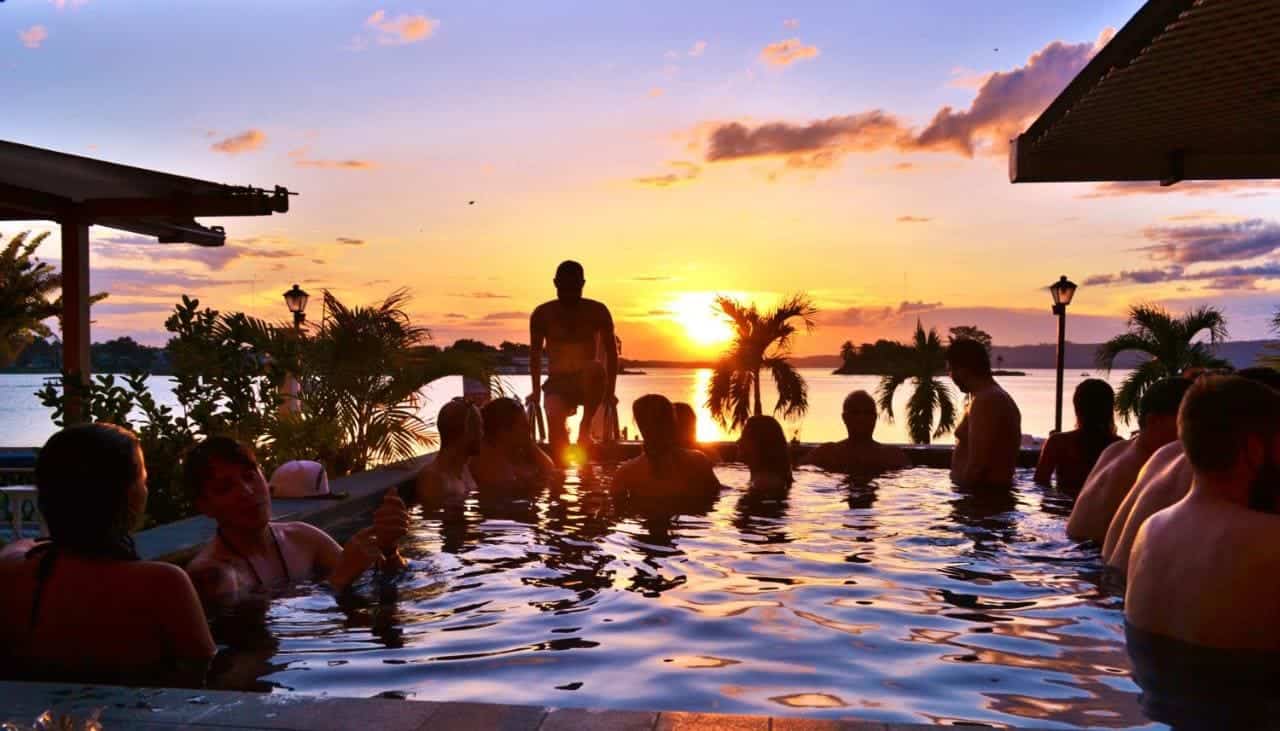 Best Hostels In Flores: Find The Perfect Stay For Backpackers 6 enjoying meeting new people at the pool at hotel peten express