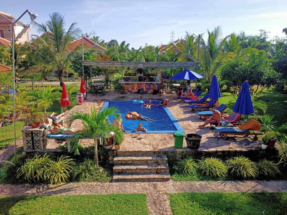 Best Hostels In Kampot Worth Booking 21 relaxing around the pool area at karma traders hostel in kampot