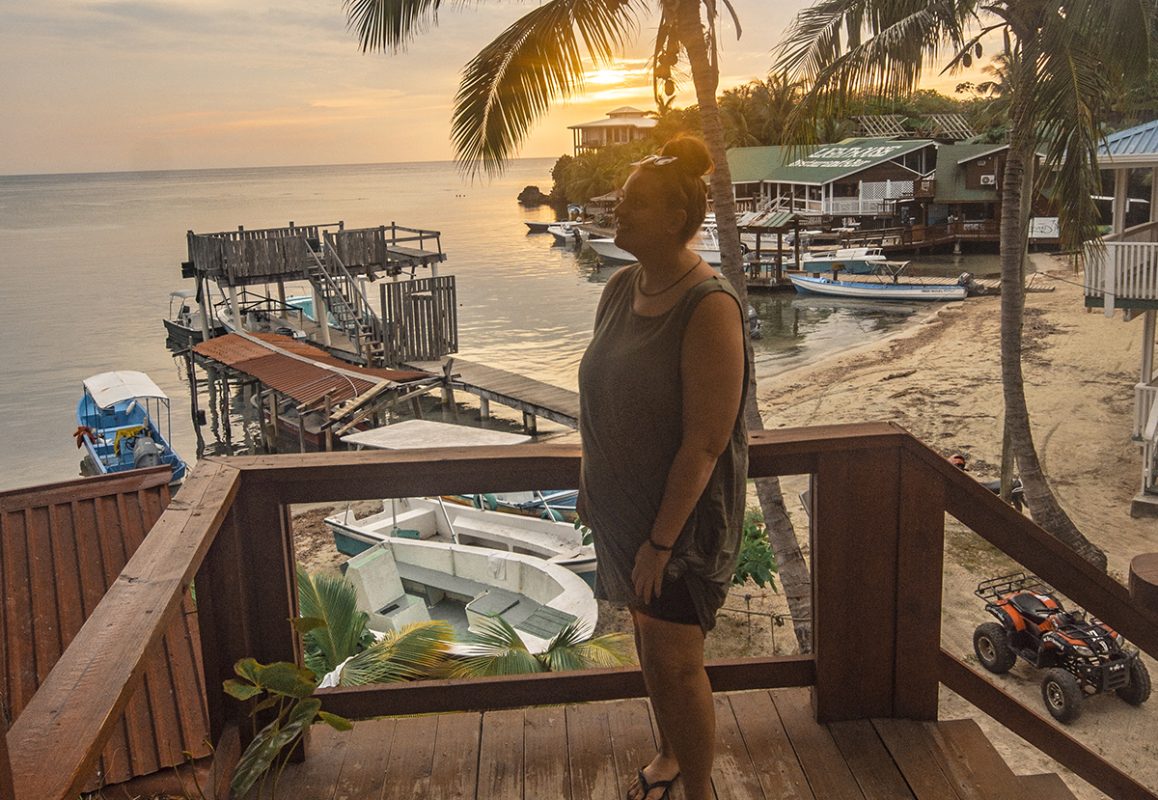 20 BEST Things To Do In Roatan: Discover Paradise (2025) 3 watching sunset from a balcony and doing some of the best things to do in roatan