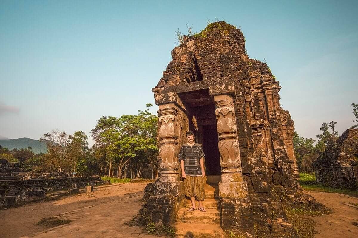 The Best Things To Do In Vietnam Recommended By REAL Travelers 8 standing in front of temple ruins at my son sanctuary outside of hoian best things to do in vietnam