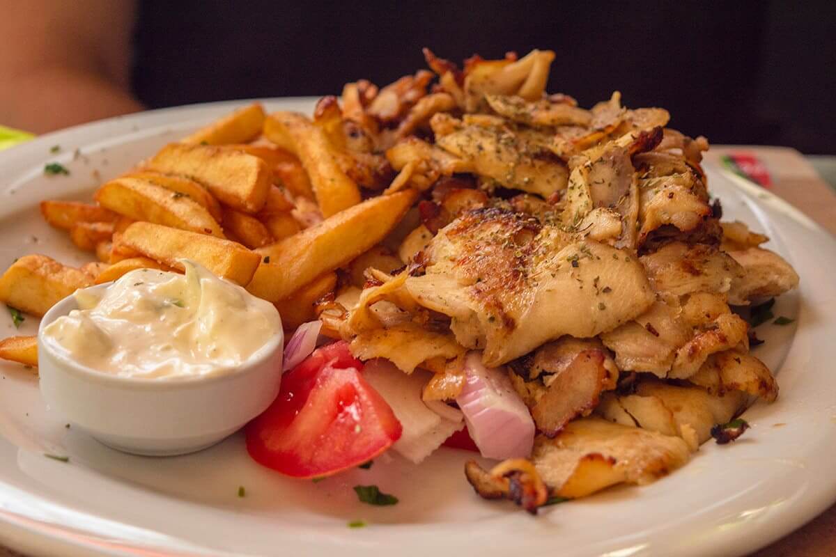 The Cost To Travel Greece And How Expensive Is It? 6 fries greek salad and shaved meat in athens cost to travel greece