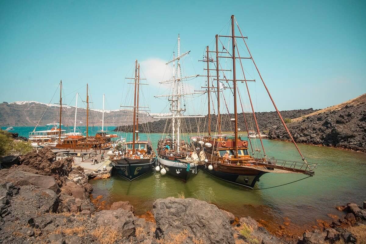 The Cost To Travel Greece And How Expensive Is It? 12 sailboats off the coast of santorini cost to travel greece