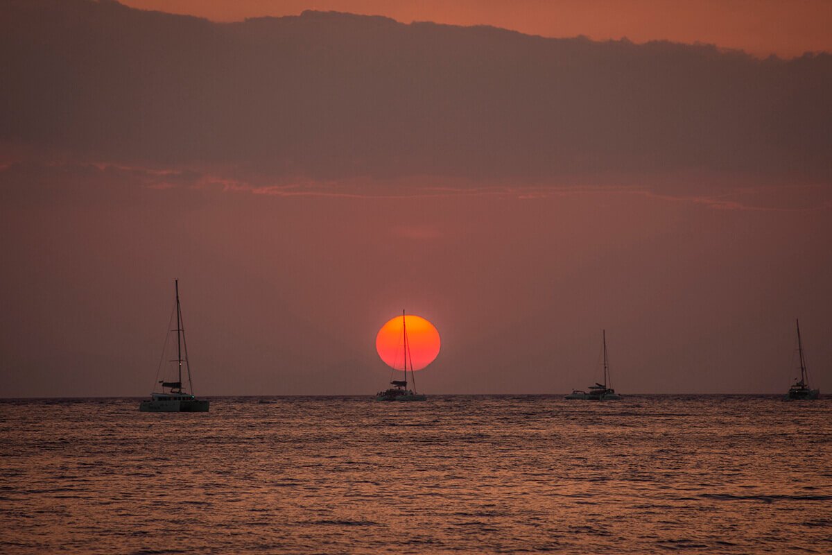 Volcano Tour In Santorini: What To Expect 16 catamarans by sunset in santorini