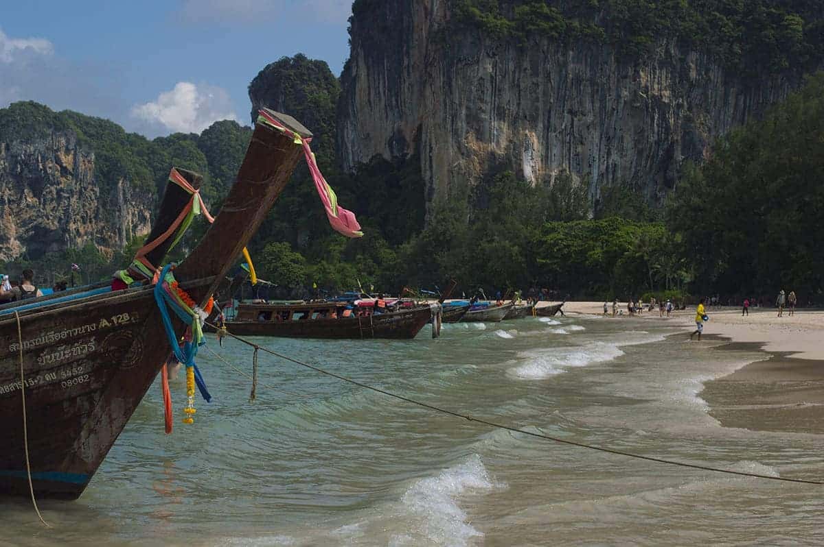 Cost To Travel Thailand: How I Spent $23 Per Day 4 boat lined up on railay beach