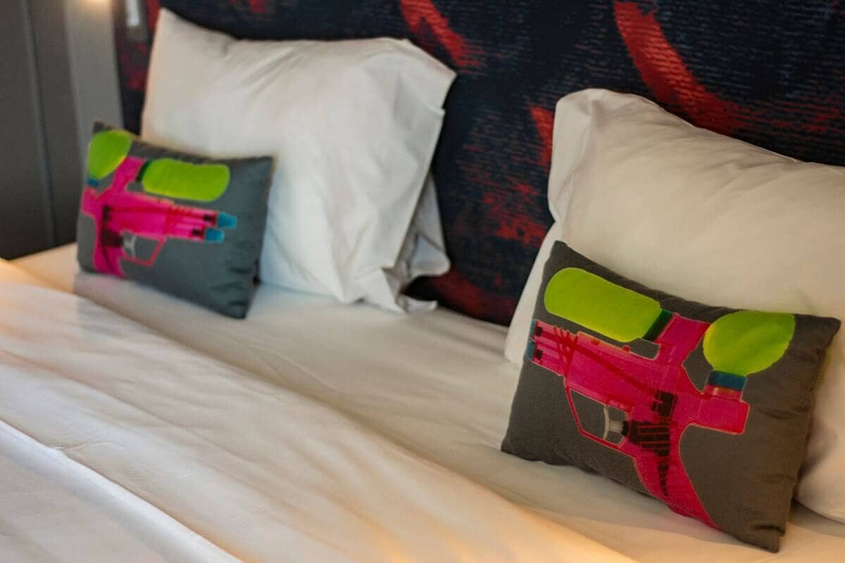 ibis Styles Bangkok Khaosan Viengtai: A Peaceful Stay On Khao San Road 8 water pistol printed pillows on bed at ibis styles khao san