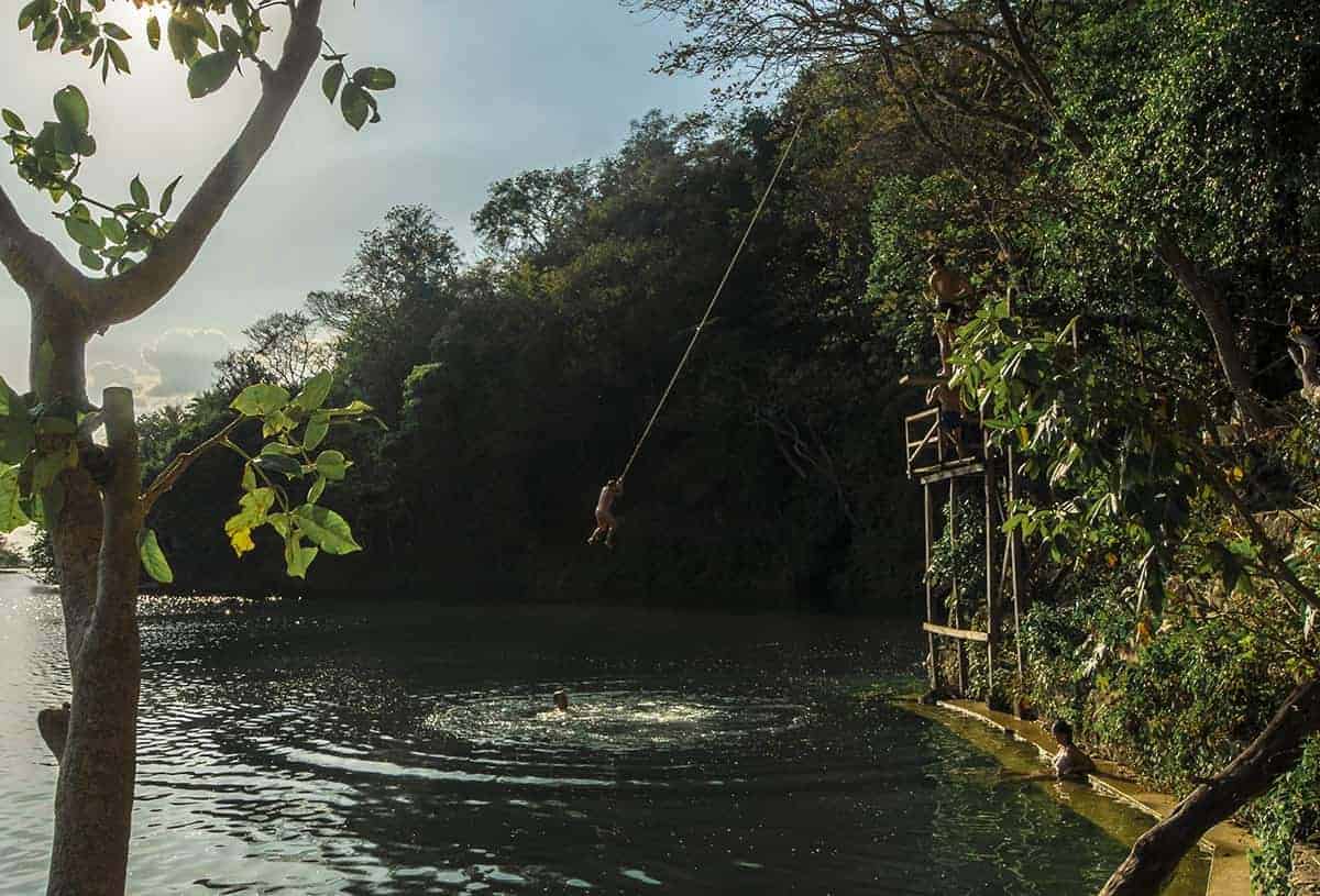 Is Flores Guatemala Worth Visiting? All You Need To Know 23 jumping into the water at jorges rope swing in flores guatemala