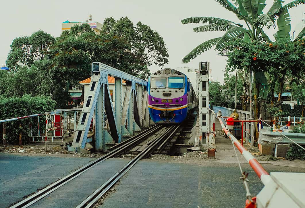 Mui Ne To Ho Chi Minh City: Travel By Bus, Train, Taxi Or Plane? 9 waiting on the train to pass by the crossing from mui ne to ho chi minh city