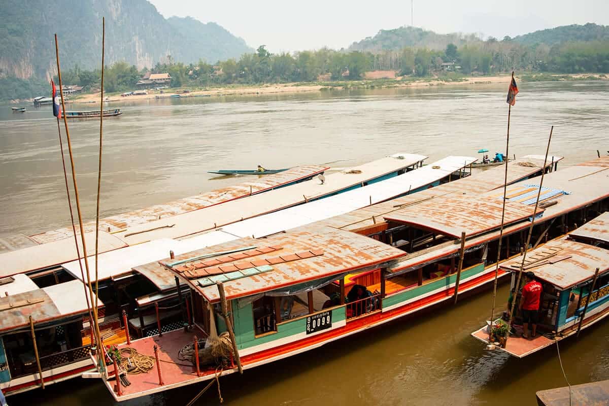 Pak Ou Caves, Luang Prabang: BEST Tips For Visiting 7 boats parked at the pier along the mekong river