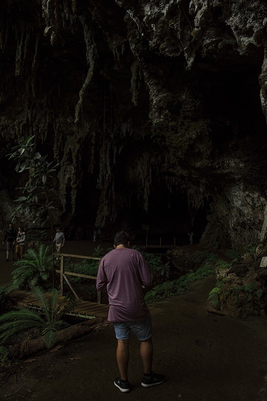 standing in front of the entrance to the cave before venturing in