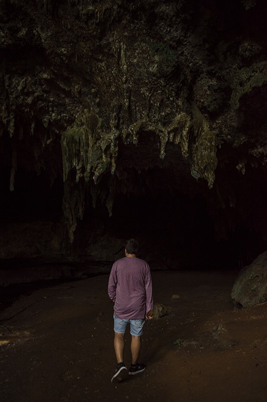 A man standing in front of Queen Hortense’s Cave.
	