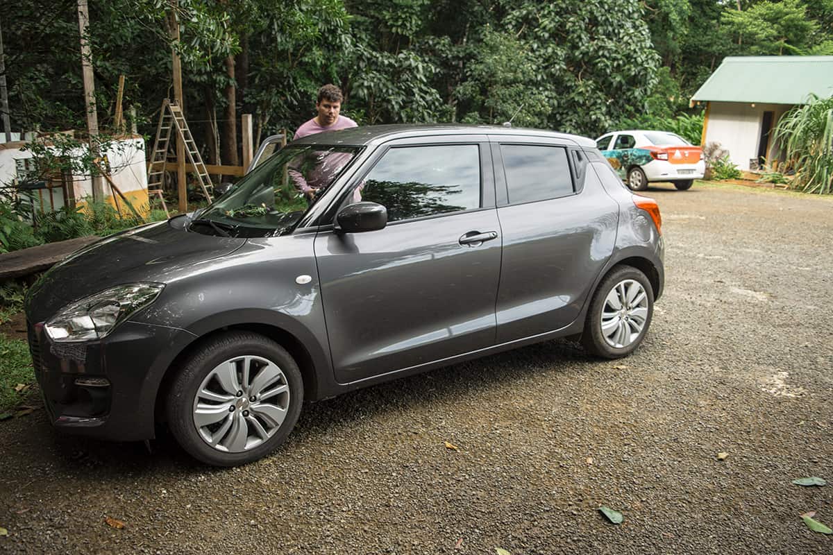 A gray Suzuki Swift parked on a dirt road near Queen Hortense's Cave on the Isle of Pines.
	