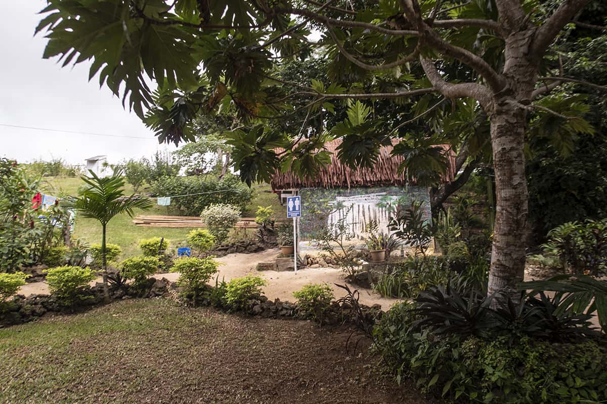 Rarru Cascades In Port Vila: BEST Tips For Visiting 2025 17 a small building with a hatched roof where you can find the changing rooms at rarru cascades