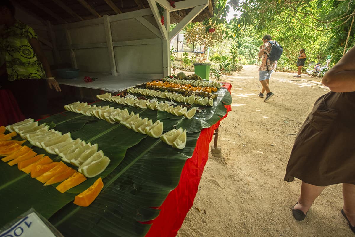 Rarru Cascades In Port Vila: BEST Tips For Visiting 2025 16 a table of fruit laying out at the entrance of rarru cascades