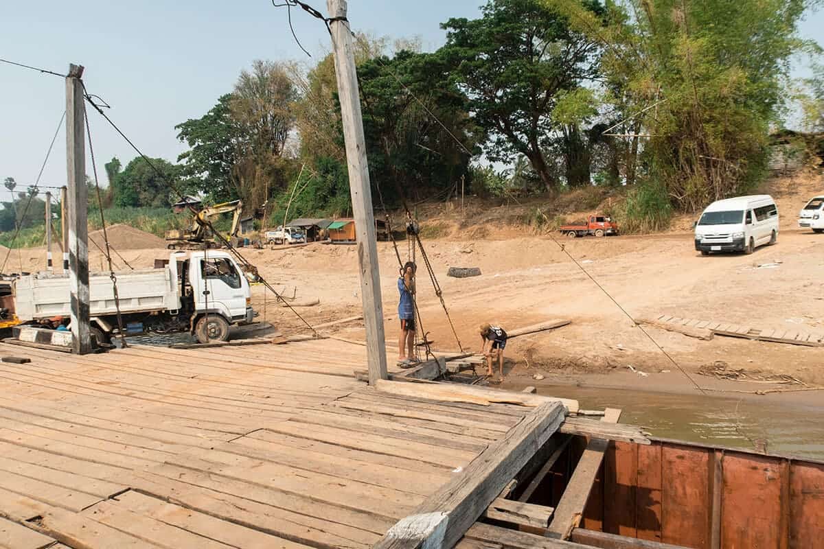 Scams In Laos: 7 Scams Travelers NEED To Know (2025) 8 crossing the river connecting don det with mainland laos