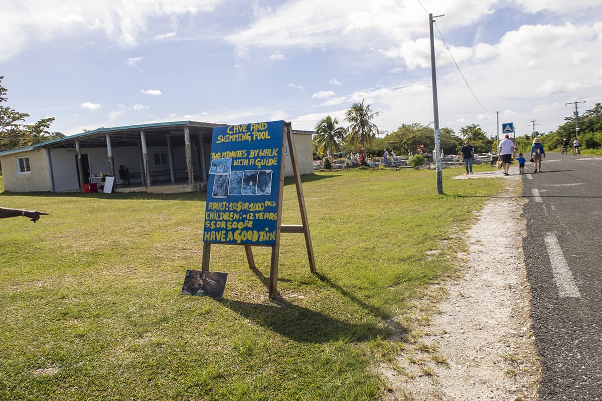 The Secret Grotto In Lifou: All You NEED To Know 2025 7 signage on the main road pointing to the cave and swimming pool at the secret grotto in lifou