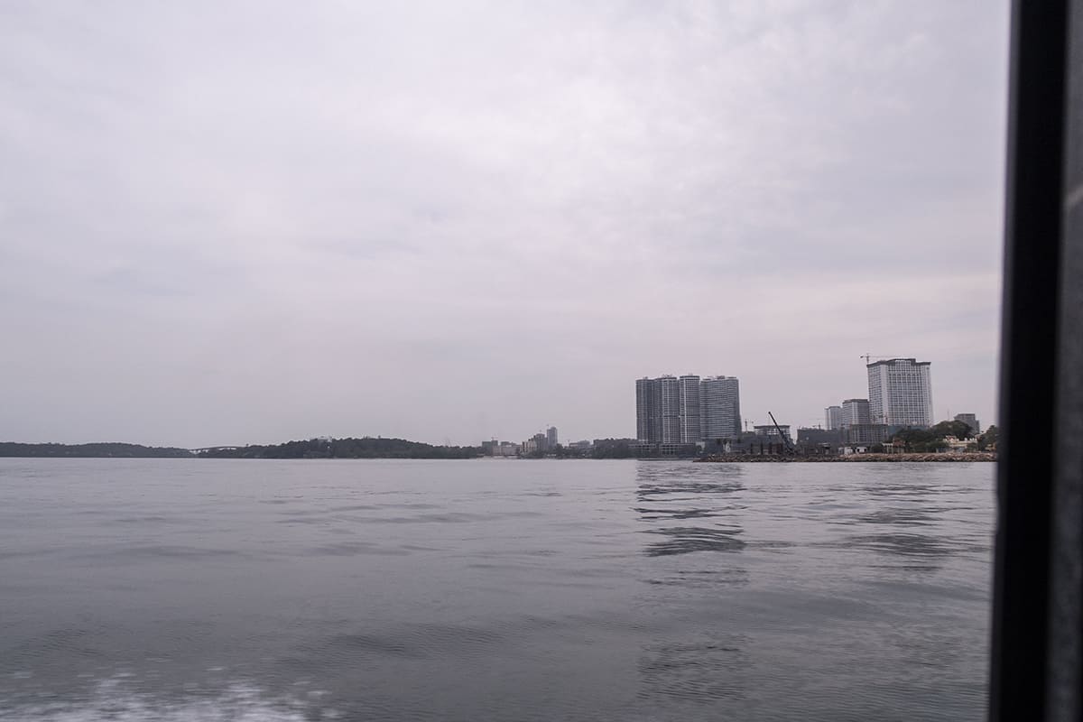 Sihanoukville to Koh Rong: How To Get To All Beaches 13 taking a speed boat from sihanoukville to koh rong with big sky scrappers on the mainland