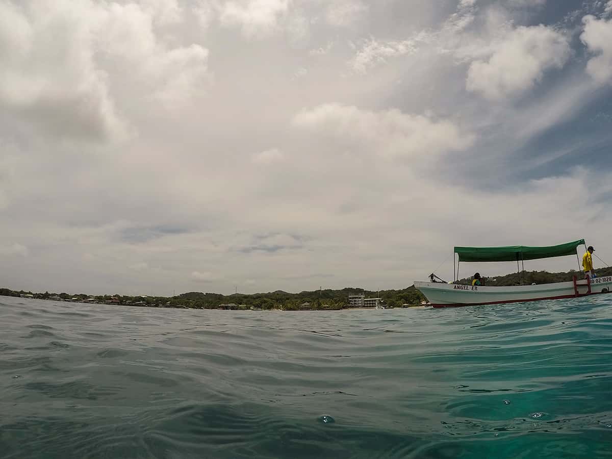 Snorkel The Blue Channel In Roatan: The Best Spot For Snorkeling 18 looking back towards our boat and the island of roatan during our snorkeling tour