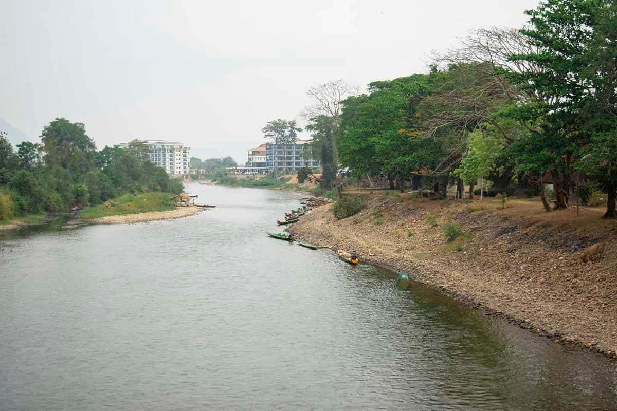Tham Chang Cave & Blue Lagoon 2: ULTIMATE GUIDE 8 walking over a bridge above the nam song river in vang vieng