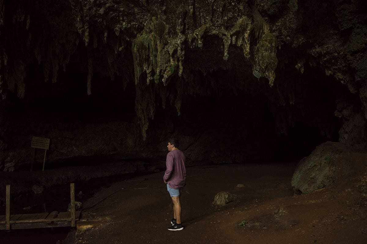 Things To Do In Isle Of Pines: For Cruise Passengers & More 11 admiring the darkness and rock formations before venturing into queen hortense cave in isle of pines