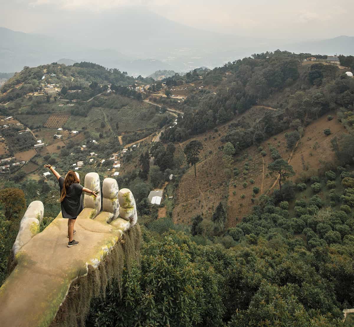Visiting Hobbitenango: What You NEED To Know 2025 11 taking that famous photo from the hand, one of the more popular attractions at hobbitenango