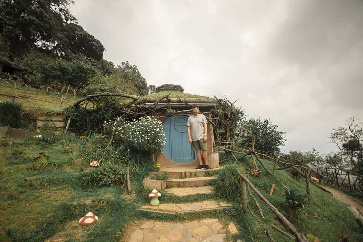 Visiting Hobbitenango: What You NEED To Know 2025 10 a checky photo outside one of the hobbit homes, peep the cute mushrooms