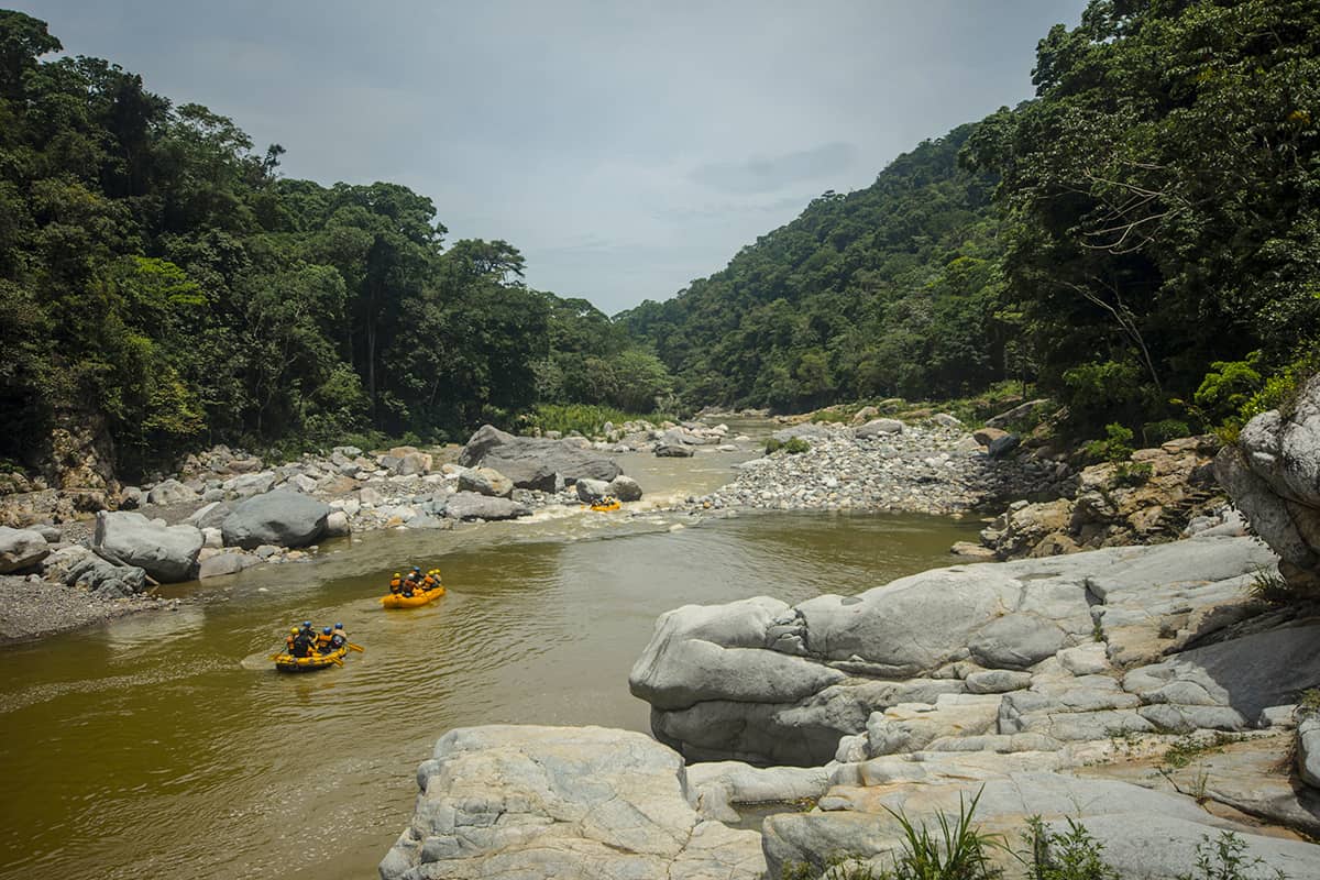 Best White Water Rafting In La Ceiba, Honduras: All You Need To Know 17 watching a group of white water rafters go past jungle river lodge on a sunny day