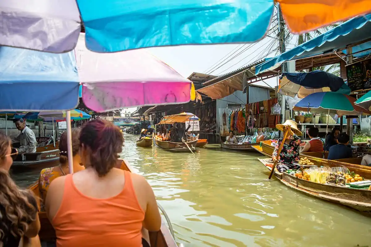 2 Days In Bangkok Itinerary: The ULTIMATE Guide 2025 12 floating through the famous damnoen saduak market with boats nearby selling food