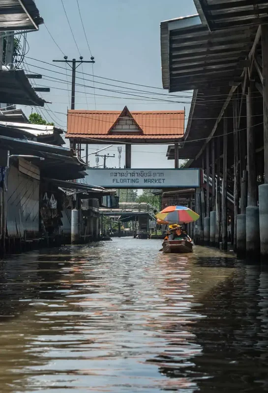 2 Days In Bangkok Itinerary: The ULTIMATE Guide 2025 19 looking down one of the canals to the bridge with the sign floating market in bangkok