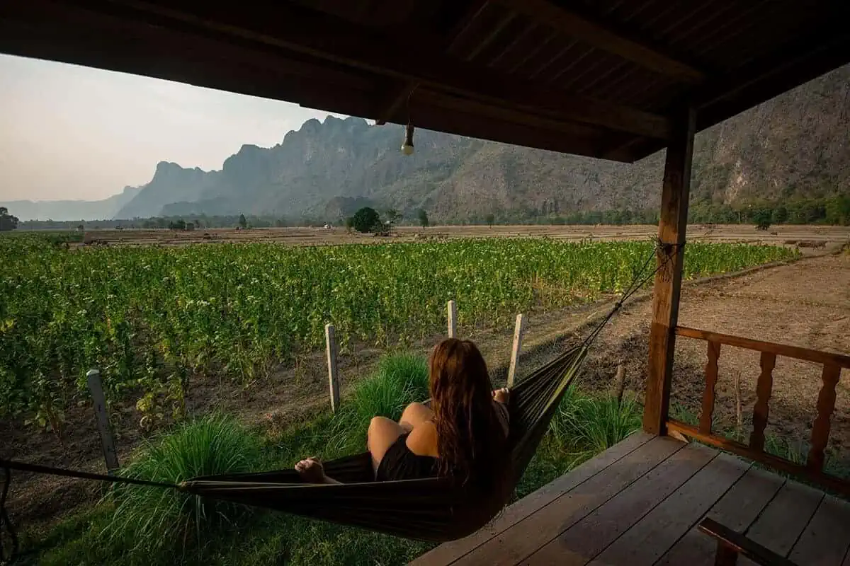 2 Weeks In Laos Itinerary: BEST Route North To South 4 tasha amy sitting on hammock in kong lor on her 2 weeks in laos itinerary