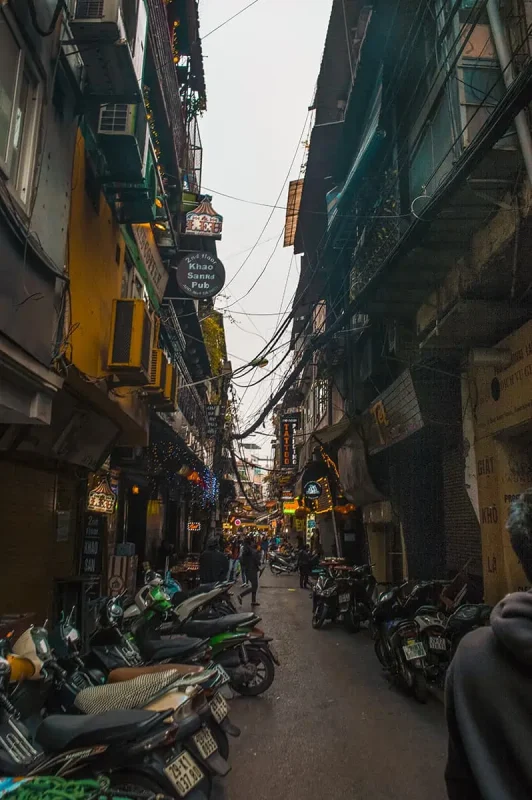 3 Week Vietnam Itinerary: BEST North To South Route 5 Narrow lane with many motorbikes parked up in Hanoi's Old Quarter
