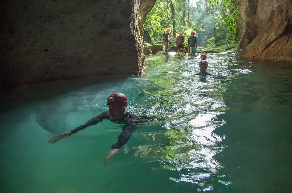 ATM Cave Tour From San Ignacio: Is It REALLY Worth The Price? 7 swimming into the atm cave from the entry point in the jungle